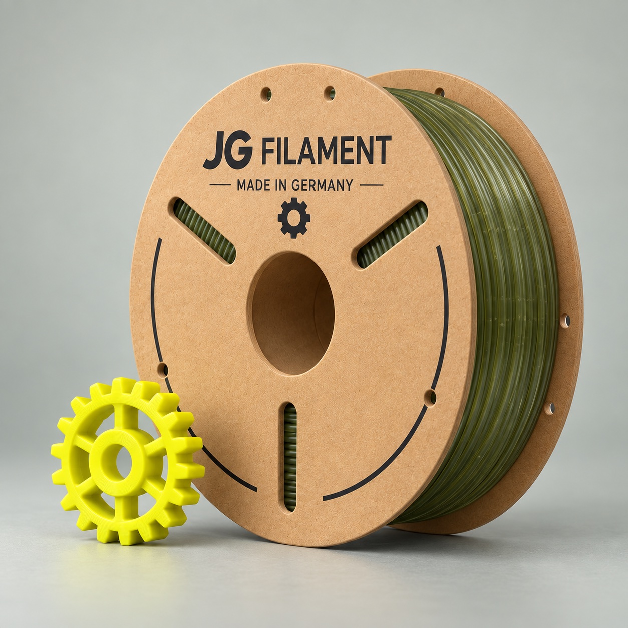 Konzeptionelle JG-Filament-Pappspule mit olivgrünem recyceltem PETG und gelbem Zahnrad