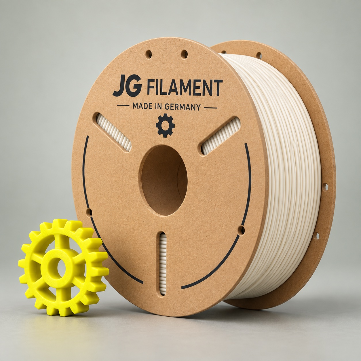 Konzeptionelle JG-Filament-Pappspule mit hellem PLA und gelbem Zahnrad